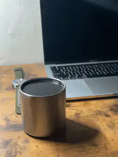 metal cup on wooden desk