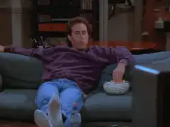 Jerry Seinfeld eating popcorn and cheering