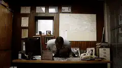 Man slams desk and throws papers