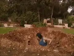 Woman in grave with beer