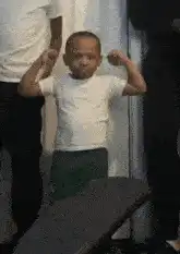 Little boy flexing muscles