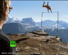 Man does backflip off high bar on mountain
