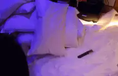 messy bed with purple light