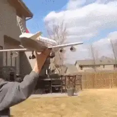 boy throws model airplane