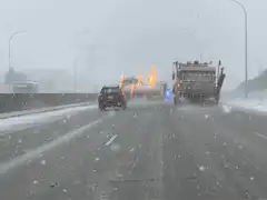 Snowplows clearing highway in heavy snow