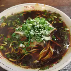 Bowl of spicy noodles with green onions
