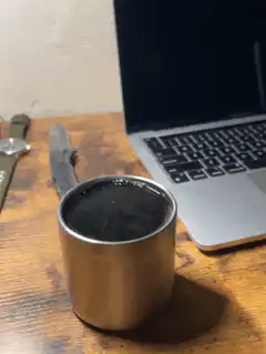 Coffee cup on desk with laptop