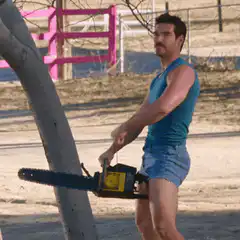 Man in blue tank top sawing tree with chainsaw