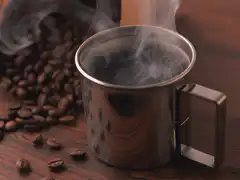 steaming metal coffee cup
