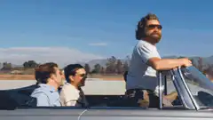 Three men in a convertible car
