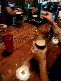 friends clinking glasses at a bar