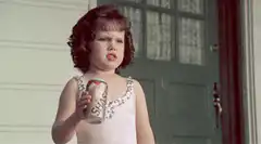 Little girl drinking from a soda can