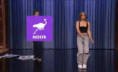 Woman dancing on stage with Nostr logo