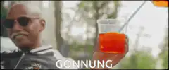 Man smiling while orange drink is poured