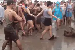Man dancing in mud at festival