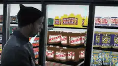 Man opens fridge door and sees sandwich