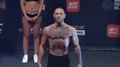 Conor McGregor flexes at UFC weigh-in
