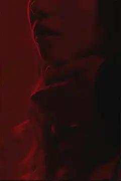 woman's neck in red light