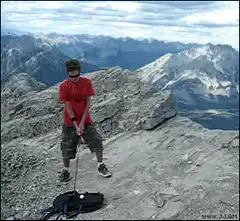 man hits golf ball off mountain cliff