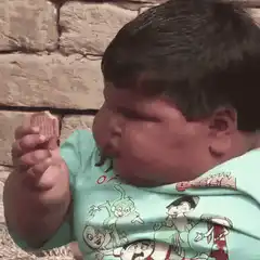 Baby eating and giving thumbs up