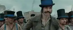 Man removes top hat and dances