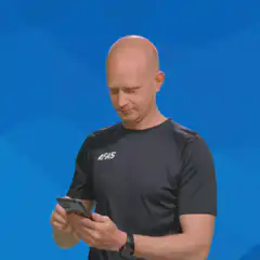 Man shows phone screen with smile