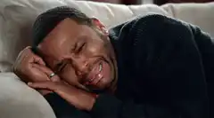 Man crying on couch