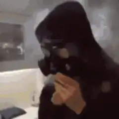 Person in gas mask breathing fire