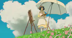 Woman painting under an umbrella in a field