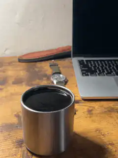Coffee cup on desk with laptop
