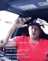 Man in car making hand gesture
