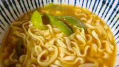 Bowl of instant noodles with green peppers