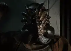 Alien creature bursting from a person's face