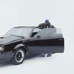 Man leaning out of black car window