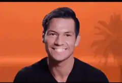 Man winking and touching his lip