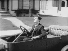 Charlie Chaplin driving a car