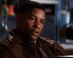 Denzel Washington puts hand on chest and smiles