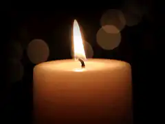 Burning candle with bokeh background