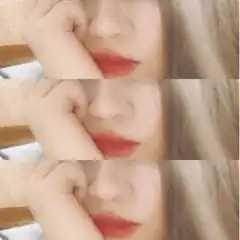 Close-up of woman with red lips and hand on face
