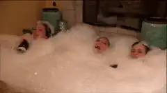 Three women relaxing in a bubble bath