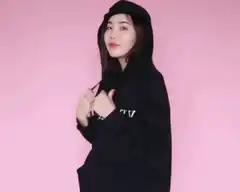 Woman pulls hoodie strings to cover face