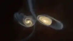 Two galaxies colliding and merging