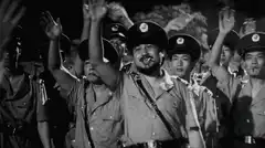 smiling man in uniform waving