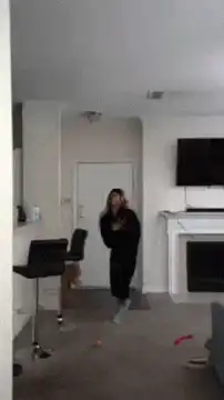 Woman dancing with dog in living room