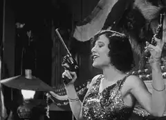 Woman firing two guns in black and white