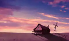 House and windmill at sunset