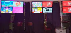 Anime-themed room with multiple screens