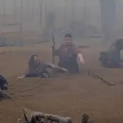 Men stuck in mud reaching for a bird