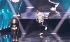 Breakdancer on stage with trophy