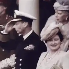 King George VI salutes while Queen Elizabeth smiles
